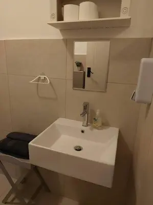 a bathroom with a white sink and a mirror at Azzure Apartments 3 sleeper Strand in Strand