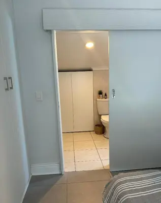 an open door to a bathroom with a toilet at Serene loft apartment in Cape Town