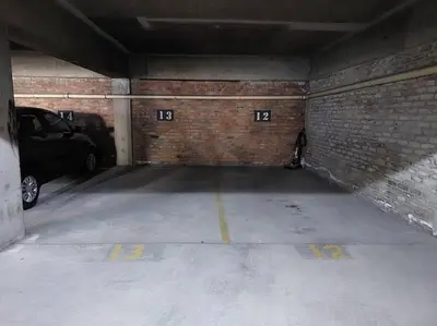 an empty parking garage with a brick wall at Azzure Apartments 4 sleeper Strand in Strand