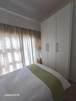 a bedroom with a bed and a large window at Azzure Apartments 4 sleeper Strand in Strand