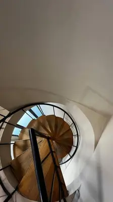 a view of a spiral staircase with a window at Cosy Central Apartment - By ARPA Hospitalities in Stellenbosch