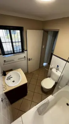 a bathroom with a toilet and a sink at Cosy Central Apartment - By ARPA Hospitalities in Stellenbosch