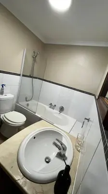 a bathroom with a sink and a toilet at Cosy Central Apartment - By ARPA Hospitalities in Stellenbosch