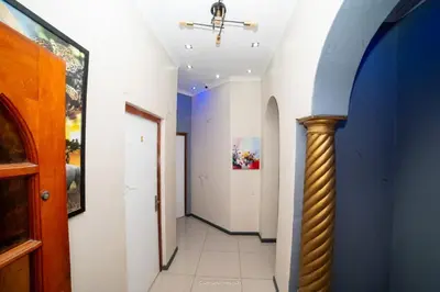 a hallway with blue and white walls and a column at Comfort on Wrench in Cape Town