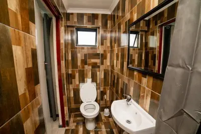 a bathroom with a toilet and a sink at Comfort on Wrench in Cape Town