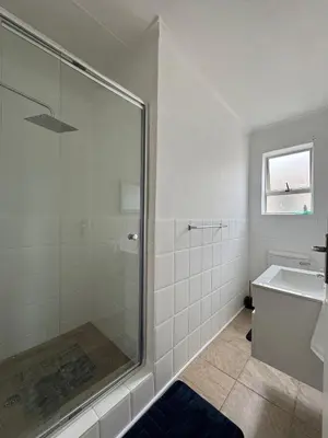 a bathroom with a shower and a sink at Hermanus Beach Club 104 in Hermanus