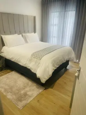 a large bed in a bedroom with a window at Private Luxury Room by 29 Holborn in Cape Town