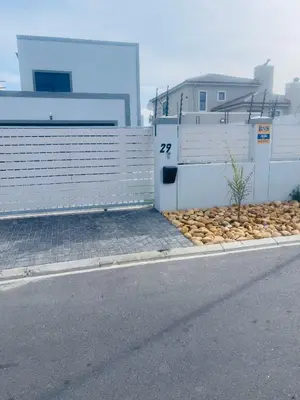 a building with a bunch of rocks next to a street at Private Luxury Room by 29 Holborn in Cape Town