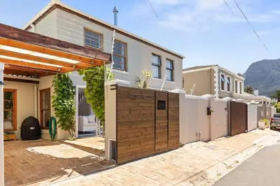 a house with a wooden gate in front of it at 2D on Nansen in Cape Town