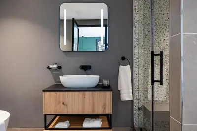 a bathroom with a sink and a mirror at Franschhoek Hotel in Franschhoek