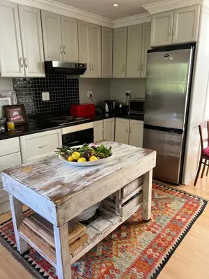 a kitchen with a table with a bowl of fruit on it at Sandpipers in Hermanus