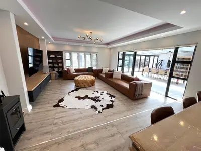 a large living room with a couch and a table at Luxurious 12 sleeper Appaloosa Villa in Cape Town