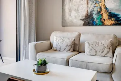 a living room with a couch and a table at Beachside Getaway in Cape Town