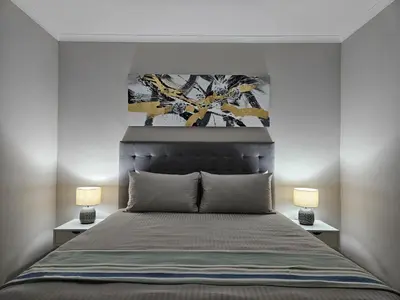 a bedroom with a large bed with two lamps at Beachside Getaway in Cape Town