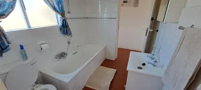 a bathroom with a tub and a toilet and a sink at Unit 75 Hermanus Beach Club in Hermanus