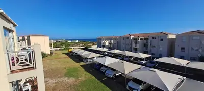 an overhead view of a row of white umbrellas at Unit 75 Hermanus Beach Club in Hermanus