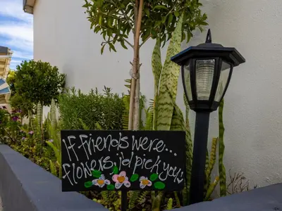 a sign next to a street light and a lamp at La Bella Vida Self Catering Apartments in Bellville