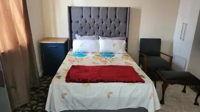 a bedroom with a large bed with a red blanket at The Vasco in Cape Town