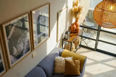 a living room with a blue couch and a table at Tyger Lake Luxury Loft in Cape Town