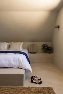 a bedroom with a bed and a pair of shoes on the floor at Spioenkop Wines Farm House in Elgin