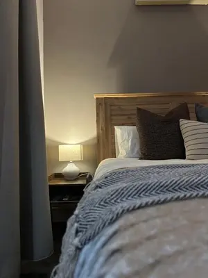 a bedroom with a bed and a lamp on a table at 7 on Huis Piron in Stellenbosch
