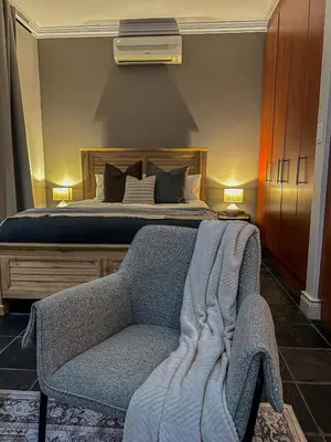 a bedroom with a bed and a couch and a bed at 7 on Huis Piron in Stellenbosch