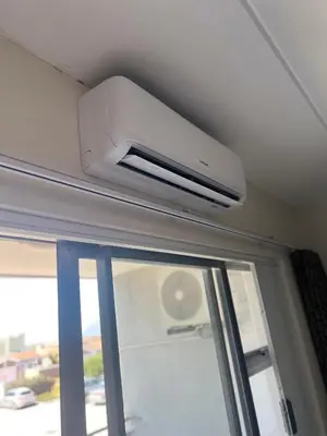 a ceiling mounted air conditioner on a ceiling above a window at Sunny Escapes Rentals in Cape Town