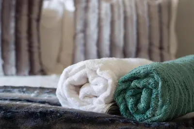 a towel sitting on top of a bed at Annebella's in Gordonʼs Bay