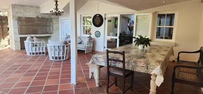 a kitchen with a table and chairs in a room at Stellenbosch Paradijs Family-home in Stellenbosch