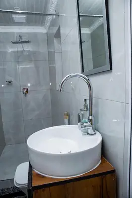 a bathroom with a white sink and a shower at one bedroom apartment A1 in Cape Town