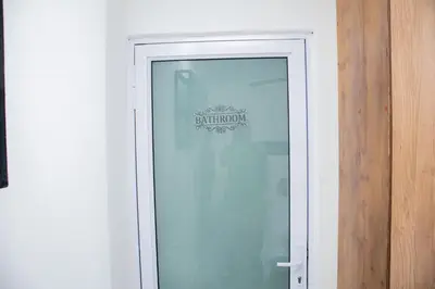 a glass door with a sign on top of it at One Bedroom Apartment A4 in Cape Town