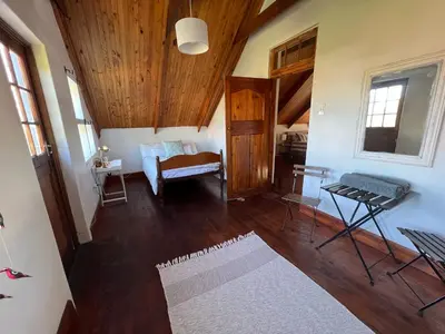 a living room with wooden floors and a wooden ceiling at 9de Laan Kleinmond in Kleinmond