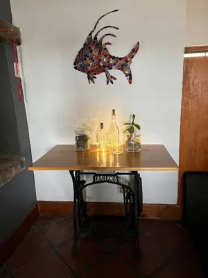 a table with a fish hanging on the wall at 9de Laan Kleinmond in Kleinmond