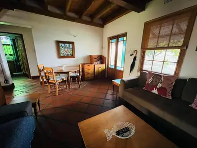 a living room with a couch and a table at 9de Laan Kleinmond in Kleinmond