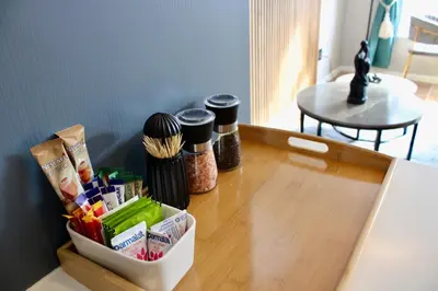 a table with a container of food on top of it at Yellow Couch Studio Apartment 1 KingBed in Cape Town