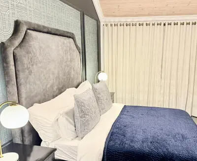 a bedroom with a bed with a blue and white at Vendôme in Somerset West