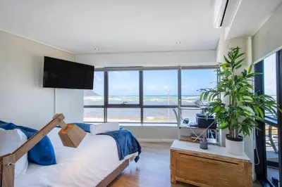 a bedroom with a bed and a large window at Atlantica202 in Strand