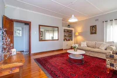 a living room with a couch and a table at 162 on 6th in Hermanus