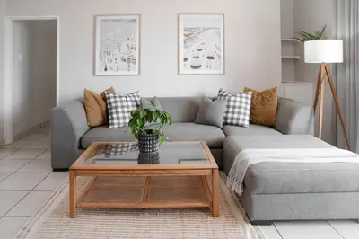 a living room with a couch and a coffee table at Seabreeze at the Beach in Strand