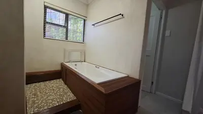 a bathroom with a bath tub and a window at Coco Cabana in Kleinmond