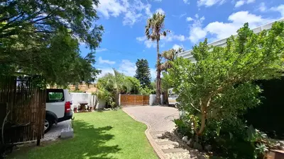 a driveway of a house with a palm tree at Coco Cabana in Kleinmond