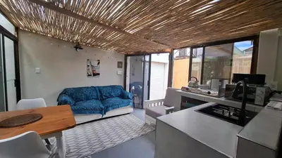 a living room with a blue couch in a kitchen at Coco Cabana in Kleinmond