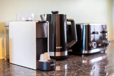 two coffee pots sitting on top of a counter at Sea Spray B303 by CTHA in Cape Town