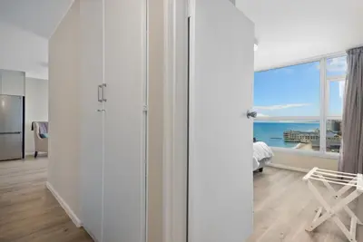 a living room with a view of the ocean at ZenDen Destinations' Seaside Sanctuary Suite in Strand