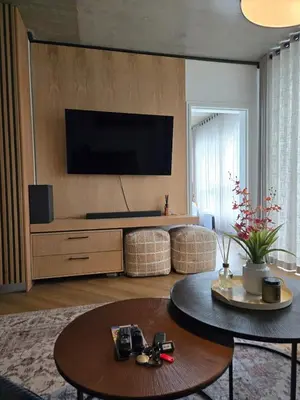 a living room with a flat screen tv on a wall at 308 Bridgewater One - Two Bedroom Apartment with Park Views in Cape Town