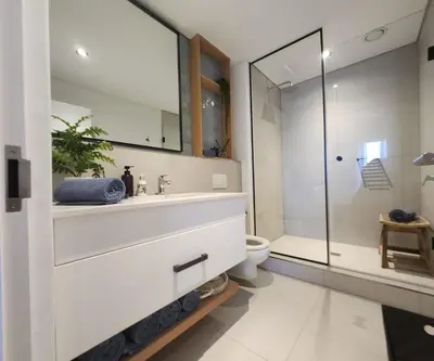 a bathroom with a sink and a toilet and a shower at 308 Bridgewater One - Two Bedroom Apartment with Park Views in Cape Town