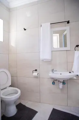 a bathroom with a toilet and a sink at Cape Dreamland in Cape Town