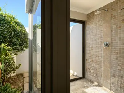 a bathroom with a shower with a glass door at Stellenbosch Luxury Apartments in Stellenbosch