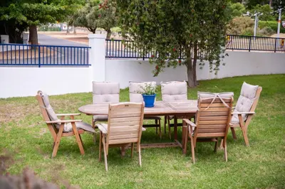 a wooden table with four chairs and a table and a table and chairsktop at theLAB Luxury Backpackers in Franschhoek