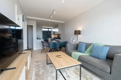 a living room with a couch and a table at Burmeister 302 - Beach Front Views with Onsite Parking in Cape Town